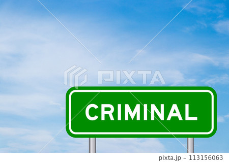 Green color transportation sign with word criminal on blue sky with white cloud background 113156063