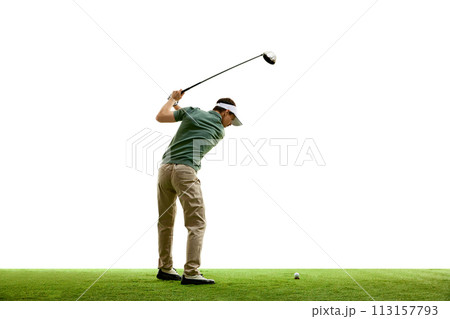 Rear view portrait of young athletic man, professional golfer playing golf on green lash grass against white studio background. 113157793
