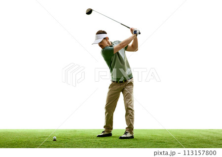 Full length portrait of golfer hitting golf shot with club on course against white studio background. Retro. Full length portrait of golfer hitting golf shot with club on course against white studio background. Retro. 113157800