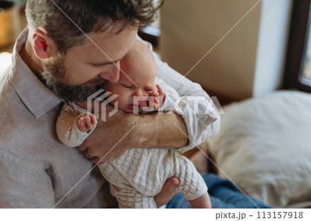 Father holding his newborn baby. Unconditional paternal love, Father's Day concept. 113157918