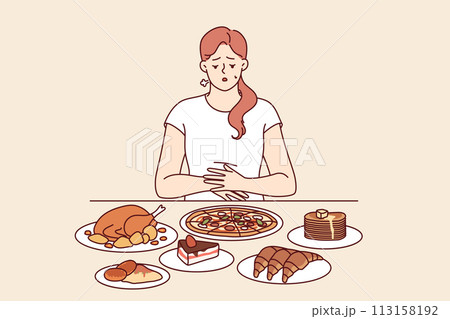 Problem of overeating in woman sitting at table with fast food, and in need of balanced diet Problem of overeating in woman sitting at table with fast food, and in need of balanced diet 113158192