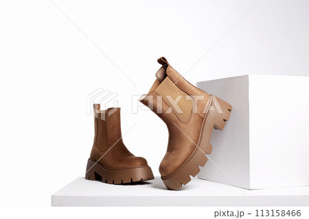 brown suede boots. fashion female shoes still life 113158466