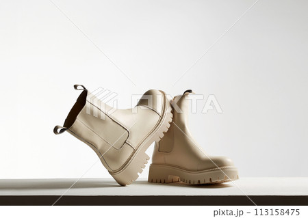 Trendy leather boots. female shoes still life. stylish chelsea boots Trendy leather boots. female shoes still life. stylish chelsea boots 113158475