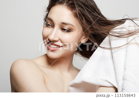 smiling young woman with towel. happy Girl with wet Hair after Shower 113158643