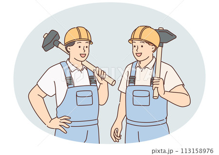 Men in builders uniforms and hardhats hold sledgehammers to demolish wall of emergency building 113158976