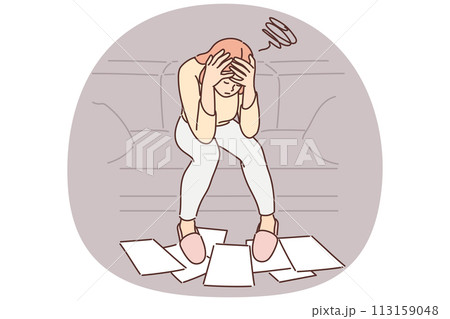 Woman frustrated with financial problems, sits with head bowed over papers scattered on floor Woman frustrated with financial problems, sits with head bowed over papers scattered on floor 113159048