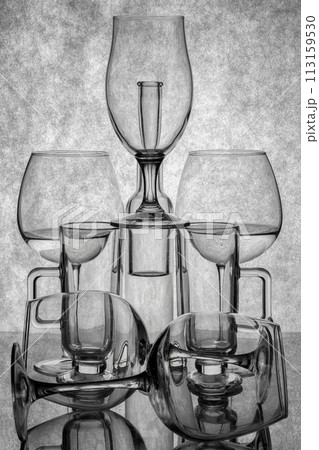 Still life with glassware on a reflective surface Still life with glassware on a reflective surface 113159530