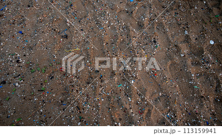 Sand on the beach covered with microplastics 113159941