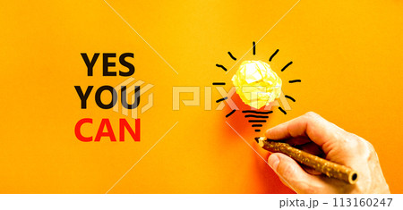 Motivational Yes you can symbol. Concept words Yes you can on beautiful orange paper. Beautiful orange background. Light bulb. Businessman hand. Business motivational Yes you can concept. Copy space Motivational Yes you can symbol. Concept words Yes you can on beautiful orange paper. Beautiful orange background. Light bulb. Businessman hand. Business motivational Yes you can concept. Copy space 113160247
