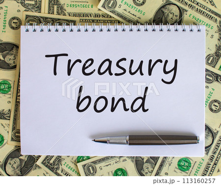 White note with space for your text on beautiful background from dollar bills and metalic pen. 'Treasury bond' text. Business concept. White note with space for your text on beautiful background from dollar bills and metalic pen. 'Treasury bond' text. Business concept. 113160257