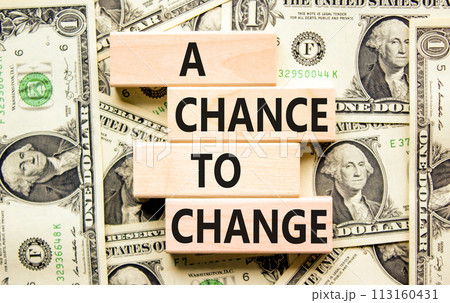 A chance for change symbol. Concept words A chance for change on beautiful wooden block. Beautiful dollar bills background. Dollar bills. Business A chance for change concept. Copy space. A chance for change symbol. Concept words A chance for change on beautiful wooden block. Beautiful dollar bills background. Dollar bills. Business A chance for change concept. Copy space. 113160431