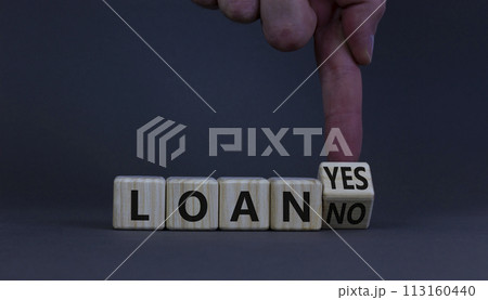 Loan yes or no symbol. Businessman turns a wooden cube and changes words loan no to loan yes. Beautiful grey table, grey background, copy space. Business and loan yes or no concept. 113160440