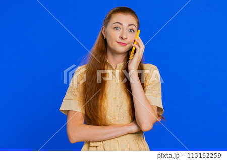 Tired sleepy woman talking on smartphone with friend making online conversation annoyed boring talk 113162259