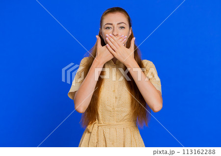 Frightened woman closing mouth with hands refusing to tell terrible secret, unbelievable truth Frightened woman closing mouth with hands refusing to tell terrible secret, unbelievable truth 113162288