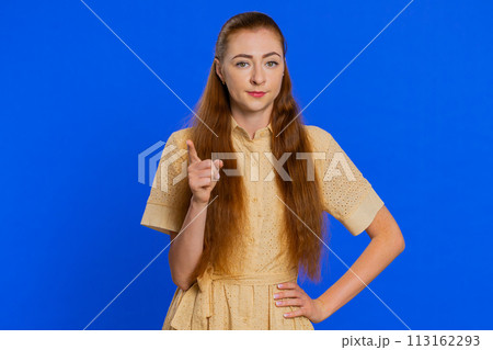 Redhead adult woman shakes finger and saying no, be careful, avoid danger mistake, disapproval sign 113162293