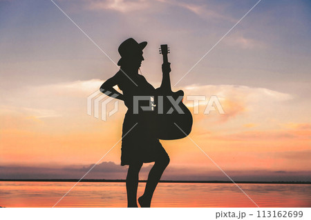 Woman and guitar with sunset silhouette download 113162699