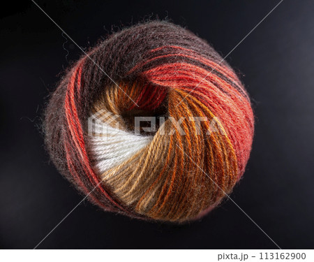A ball of yarn with a red stripe and a white stripe 113162900