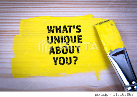 What's Unique About You. Yellow paint and paint brush on wooden texture background 113163868