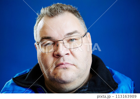 Boring look of an overweight man, 47 years old, of European appearance. 113163989