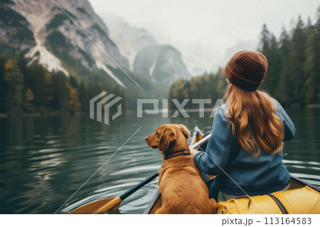 Rear view of woman paddles her canoe Rear view of woman paddles her canoe 113164583