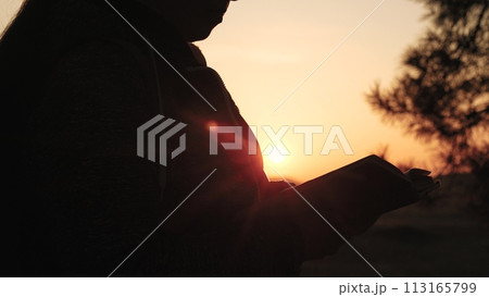 girl woman praying at sunset, hand sunset faith pain, asking heaven for help, bible book, tranquil sunset praying, young woman spirituality, divine connection sunset, spiritual growth dusk 113165799