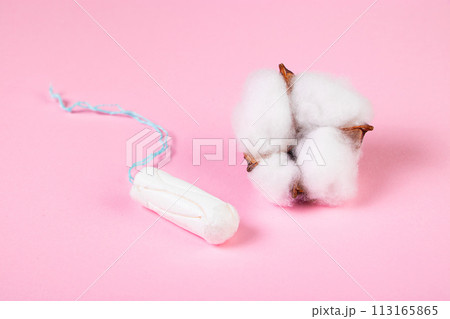 Hygienic tampon and cotton flower on pink background. Feminine menstrual hygiene product. Womens health concept. 113165865