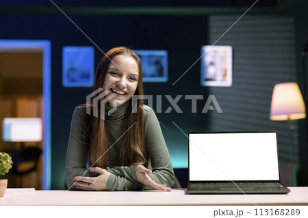 Happy young tech expert presenting mockup laptop in entry level low budget price range. Cheerful gen Z content creator reviewing isolated screen notebook in front of internet fanbase Happy young tech expert presenting mockup laptop in entry level low budget price range. Cheerful gen Z content creator reviewing isolated screen notebook in front of internet fanbase 113168289