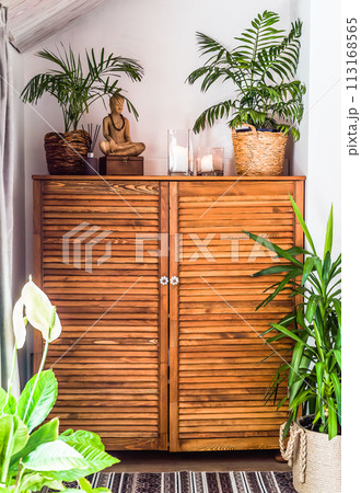 wooden chest of drawers with decorations and flowers in the interior 113168565