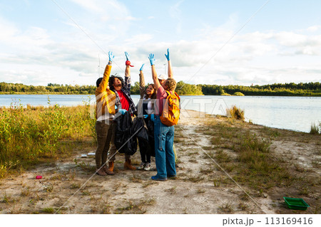 Volunteer Team Jubilantly Raises Hands After Shoreline Cleanup Volunteer Team Jubilantly Raises Hands After Shoreline Cleanup 113169416