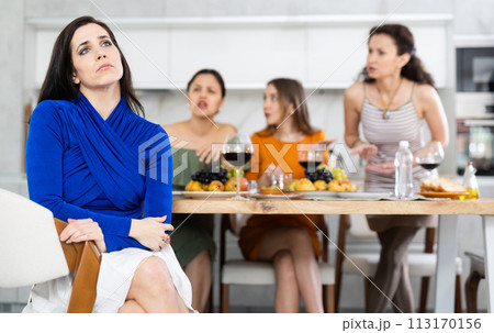 Group of women quarrel with spanish woman 113170156