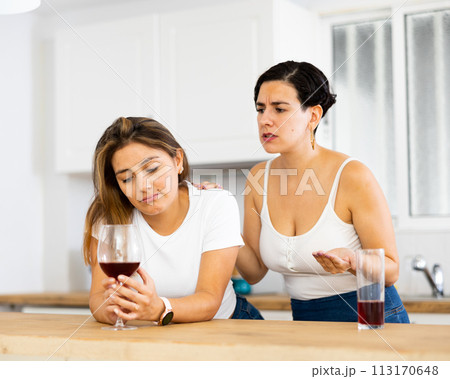 Sadness woman has problem, girlfriend consoling her at table in kitchen 113170648