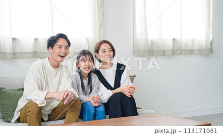 リビングルームでテレビを見ながら喜ぶ親子 113171081