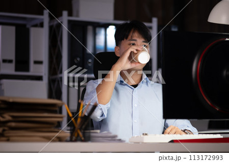 Businessman working overtime at his office He felt tired. 113172993