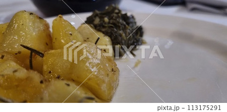 Rosemary roasted potatoes and spinach on plate Rosemary roasted potatoes and spinach on plate 113175291