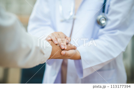 doctor hand holding the patient's hand. To encourage and comfort the patient so that the patient is not sad and worried. doctor hand holding the patient's hand. To encourage and comfort the patient so that the patient is not sad and worried. 113177394