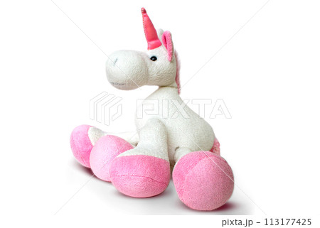 Pink soft unicorn toy sitting at white background. Isolated studio image Pink soft unicorn toy sitting at white background. Isolated studio image 113177425