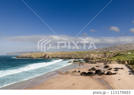 Durness Beach in Scotland, with azure waters, golden sands, dark rocks, surrounded by cliffs and sky Durness Beach in Scotland, with azure waters, golden sands, dark rocks, surrounded by cliffs and sky 113179883