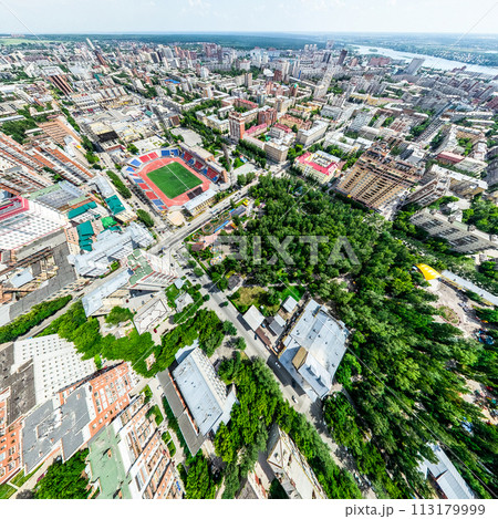 Aerial city view with crossroads and roads, houses, buildings, parks and parking lots. Sunny summer panoramic image Aerial city view with crossroads and roads, houses, buildings, parks and parking lots. Sunny summer panoramic image 113179999
