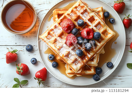 Wake to a morning delight with freshly baked waffles adorned with berries and syrup drizzle, cafe menu 113181294