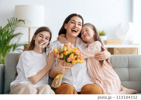 daughters and mom with flowers 113184332