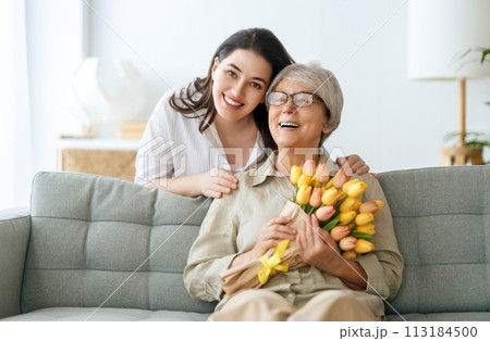 woman and her mother with flowers tulips 113184500