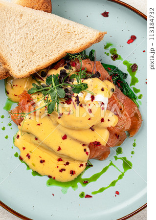 Egg benedict with salmon and toasts Egg benedict with salmon and toasts 113184732