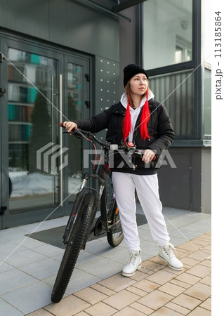 Young woman went out for a bike ride in winter 113185864