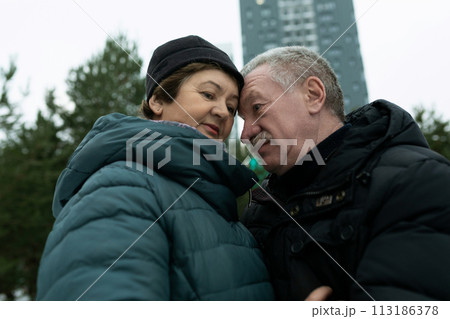 European mature family hugging each other while walking 113186378