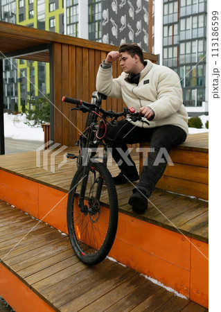 A handsome young guy stopped to rest while cycling A handsome young guy stopped to rest while cycling 113186599