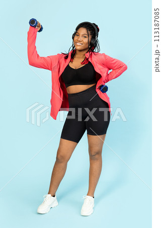 Active Woman Exercising with Dumbbells and Enjoying Music Active Woman Exercising with Dumbbells and Enjoying Music 113187085