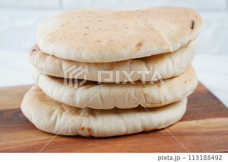 A stack of Pita bread(flat bread) on wooden board 113188492