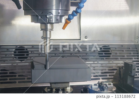 The CNC milling machine rough cutting the graphite electrode parts. 113188672