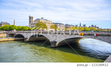 Arched Pont au Change spans the Seine River against a backdrop of Parisian architecture on a clear day. Paris, France Arched Pont au Change spans the Seine River against a backdrop of Parisian architecture on a clear day. Paris, France 113189412