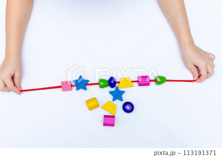 Colourful child's bead bracelet, isolated on a white background 113191371